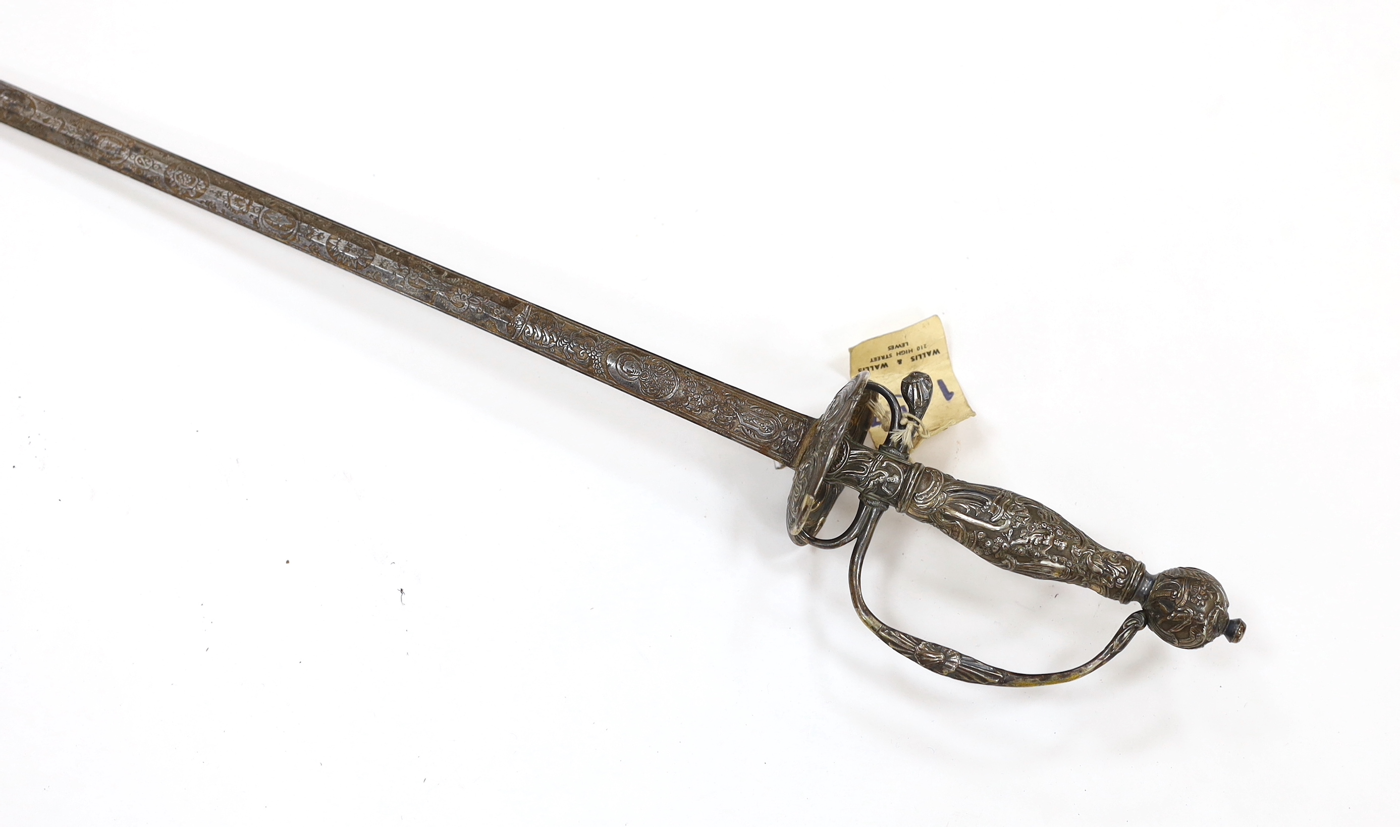 A French silver hilted small sword, c.1770, the guard, pommel and grip all chiselled with putti, flowers and rococo devices, blade etched with commensurate designs with retaining traces of gilding, blade 74cm